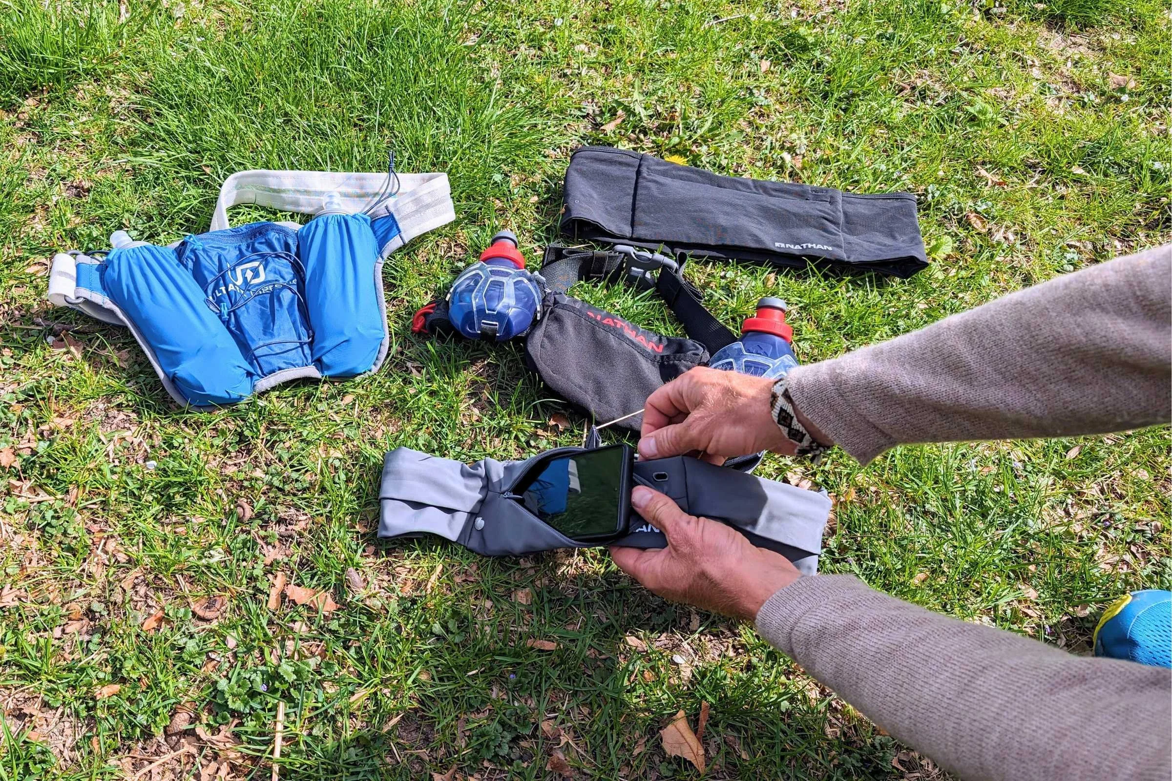 A collection of running belts featuring zippered pockets for security.