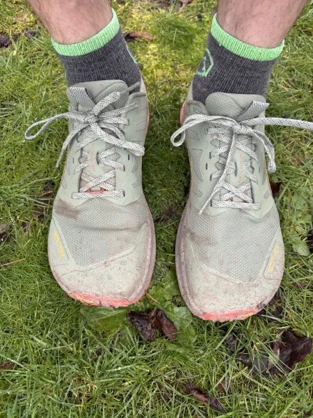 Altra Lone Peak 9+ GTX trail shoe in Dusty Olive colorway on a natural surface.