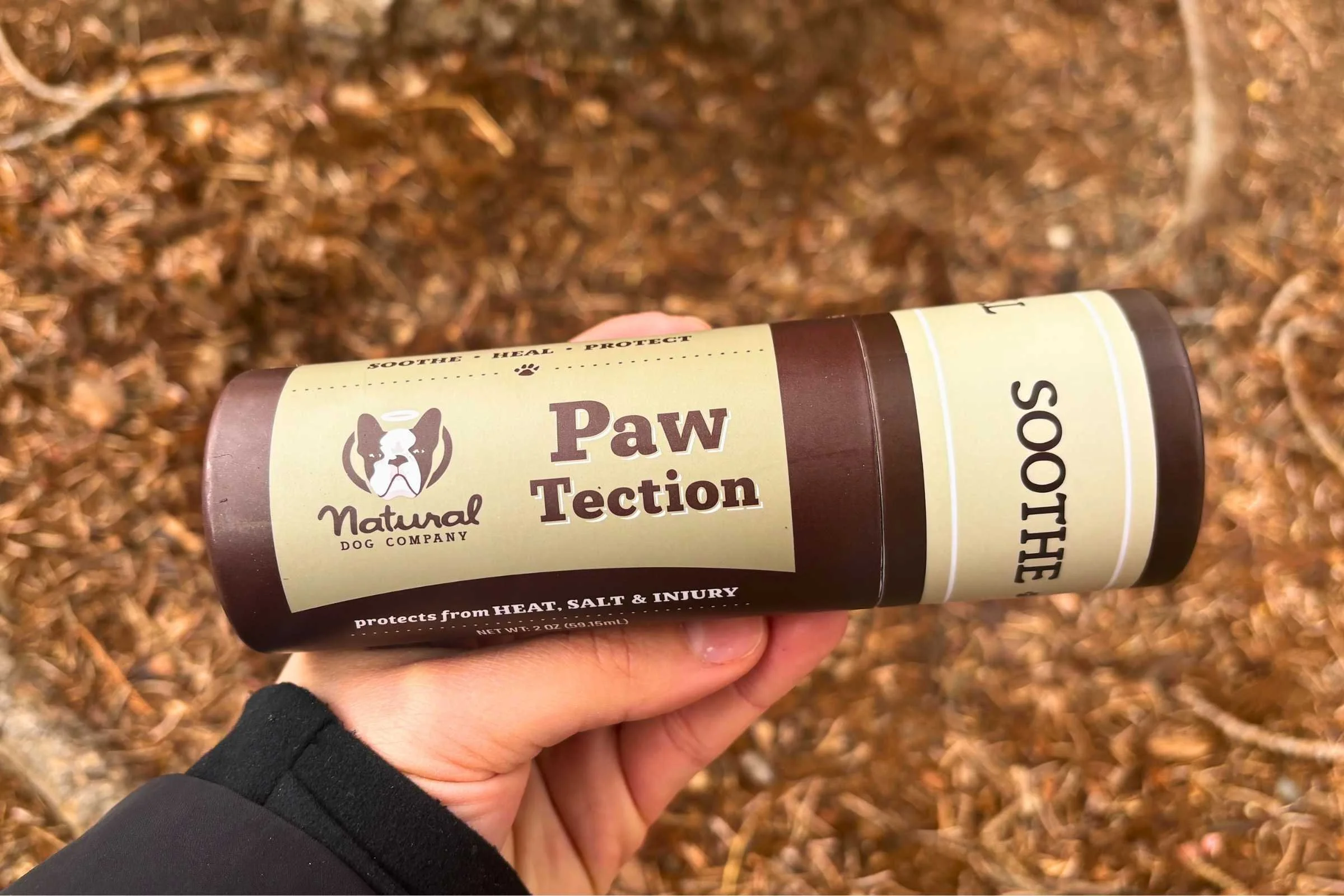 A tube of Natural Dog Company PawTection balm standing upright.