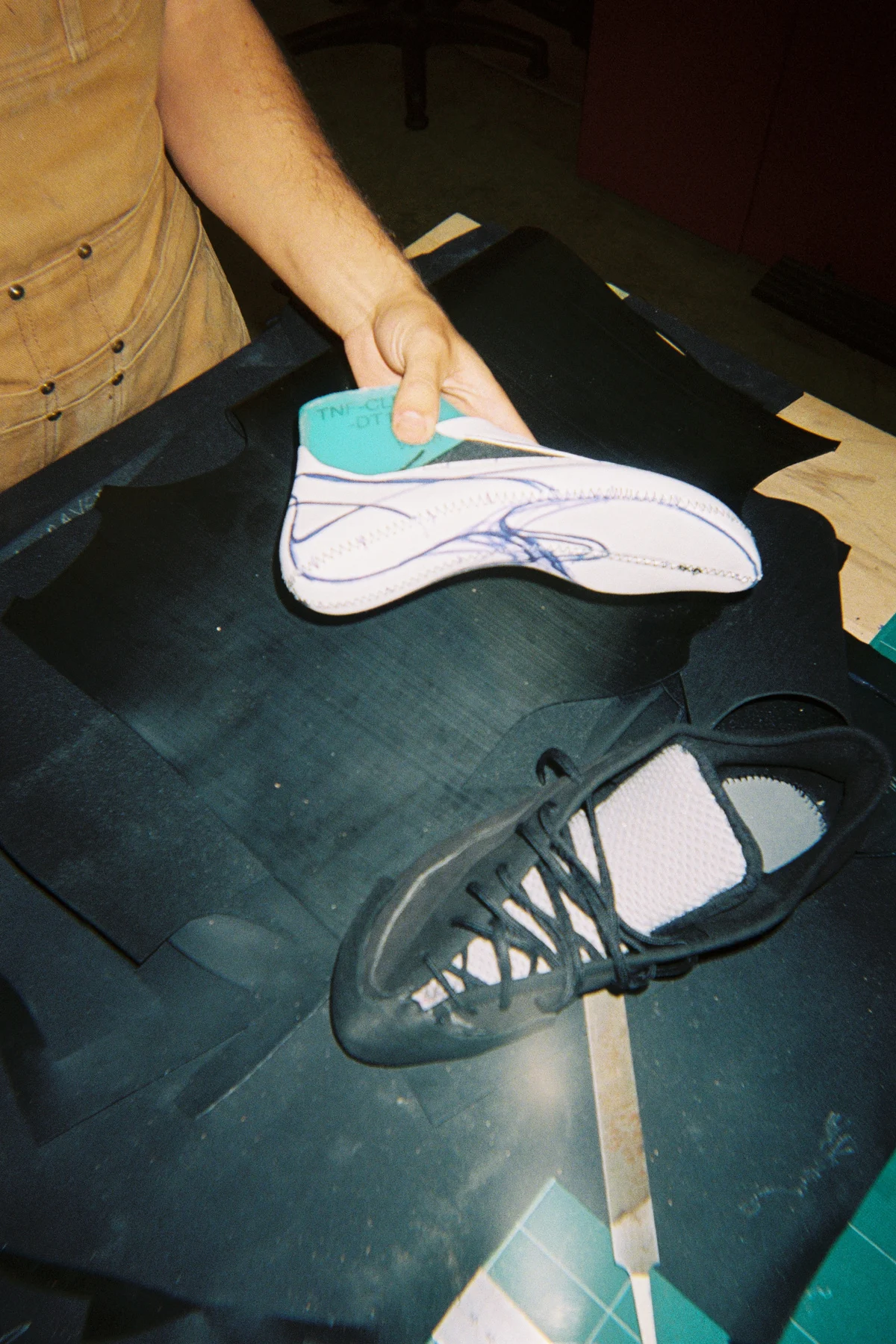 Detail shot of the rubber rand wrapping the forefoot of a Village PM skate shoe.