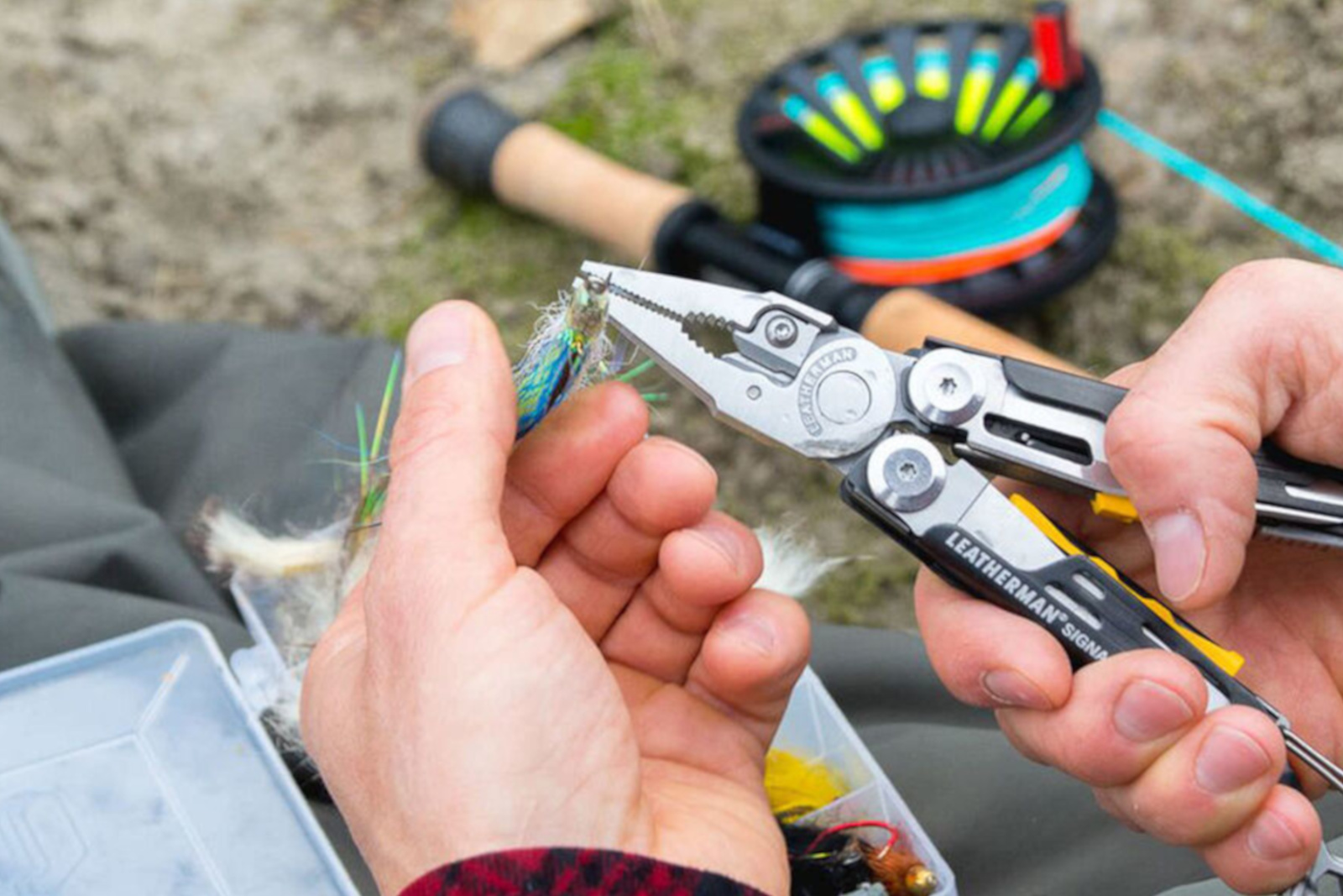 A yellow and black Leatherman Signal multi-tool shown partially opened.