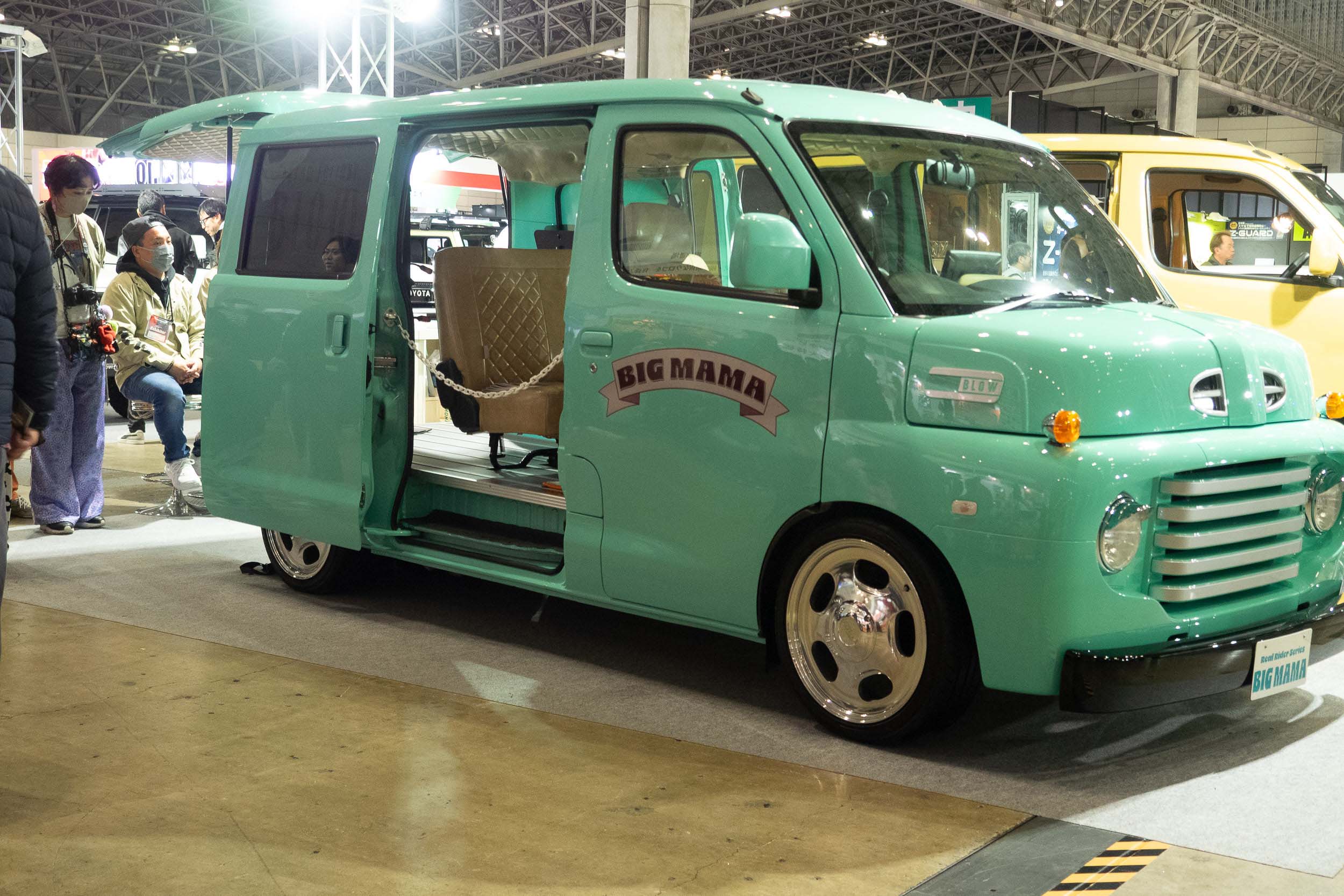 A sea-foam green Toyota Town Ace modified with a retro Ford F1-style front end.